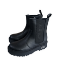 Tronchetti neri da bambino in pelle con suola alta e logo laterale visibile, stile casual